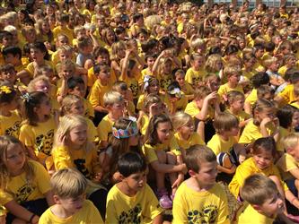 Large group of students wearing yellow t-shirts